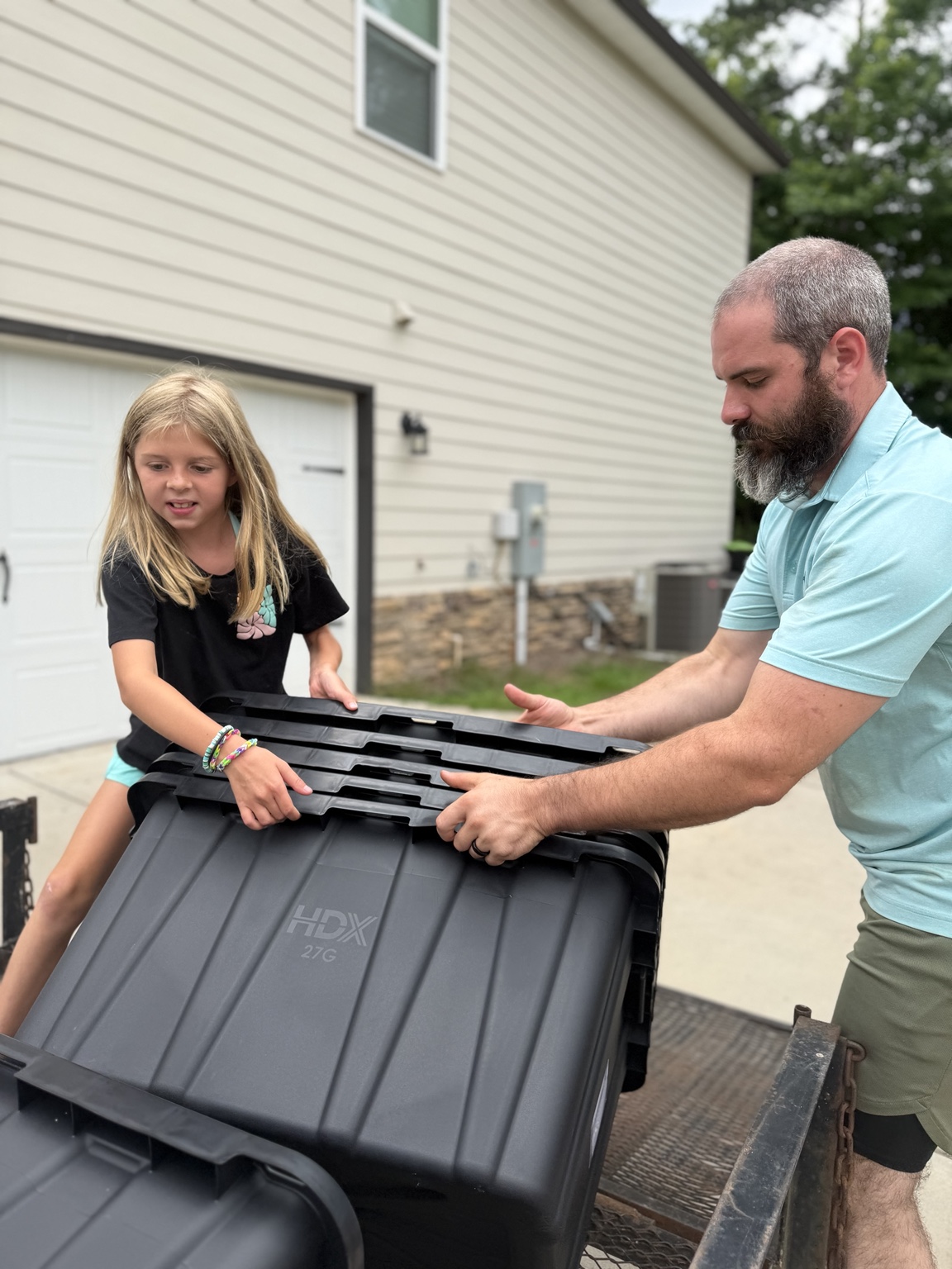 Emmarie and Justyn loading moving totes together