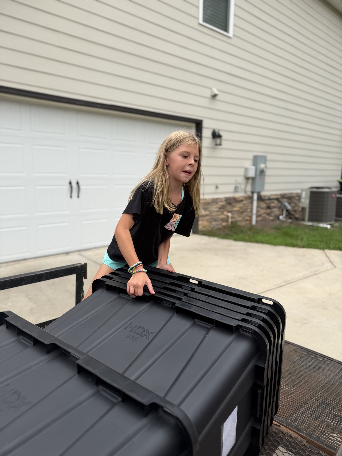 Emmarie helping load moving totes