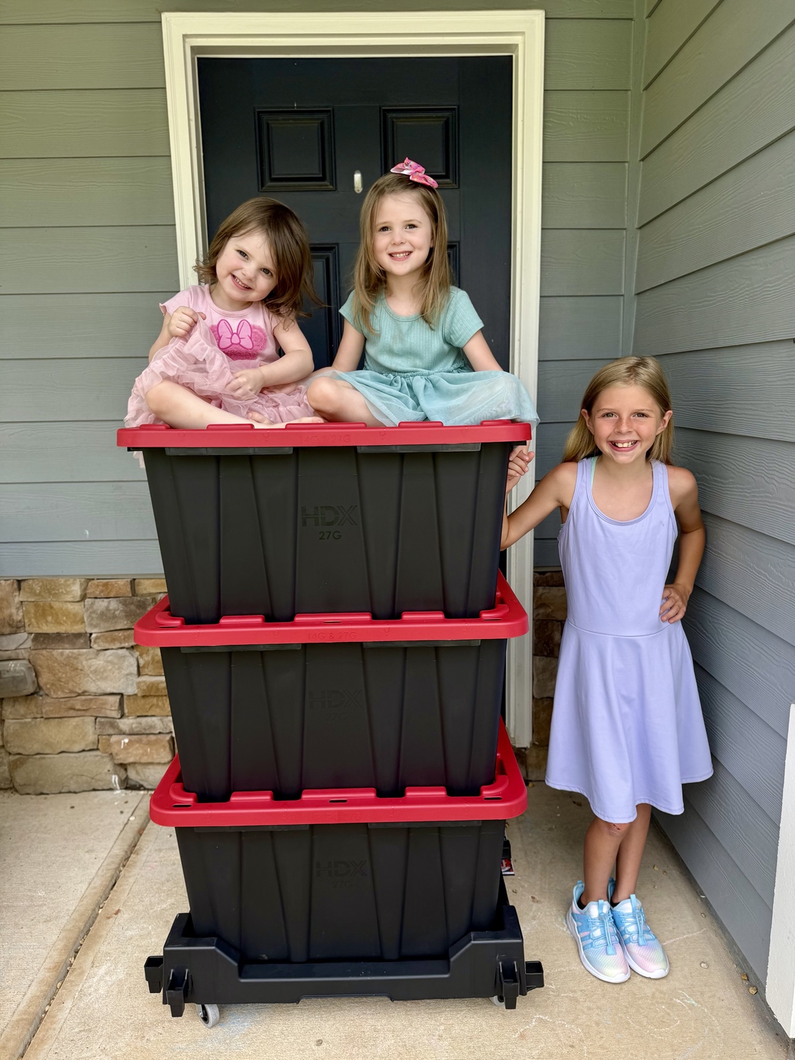 The Weaver children with moving totes